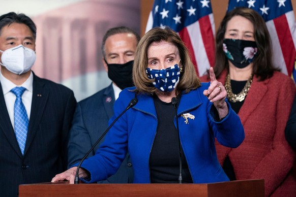 TOPSHOT - US Speaker of the House Nancy Pelosi, with House impeachment managers, speaks to the press after the Senate voted to acquit former US President Donald Trump, in the US Capitol in Washington, ...