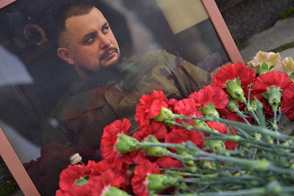 Russia LPR Military Blogger Killing 8404390 04.04.2023 Flowers are placed near a portrait of Russian military blogger Vladlen Tatarsky, real name Maxim Fomin, who was killed in a cafe explosion in St. ...