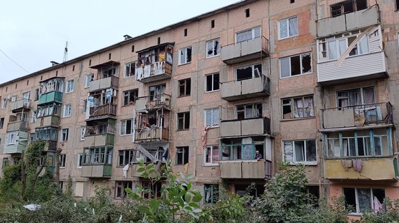 DONETSK PEOPLE S REPUBLIC - SEPTEMBER 14, 2022: An apartment building stands damaged in the rural town of Holmivskyi, Horlivka Municipality. Shelling from the Ukrainian Armed Forces resulted in four l ...