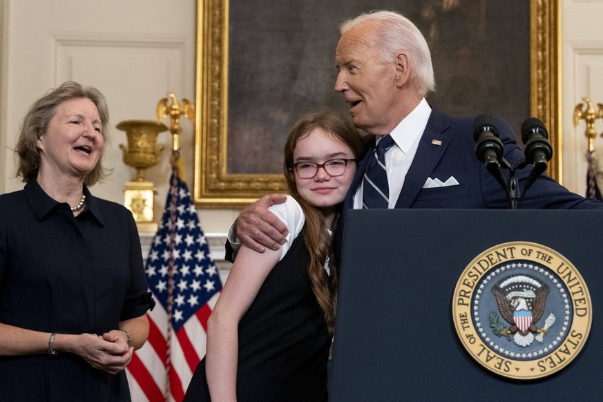 U.S. President Joe Biden hugs Miriam Butorin daughter of Alsu Kurmasheva during remarks on freeing Americans detained in Russia along side families hostages Evan Gershkovich and former U.S. Marine Pau ...