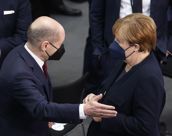 BERLIN, GERMANY - FEBRUARY 13: German Chancellor Olaf Scholz (L) and former chancellor Angela Merkel (R) arrive for the assembly of the Federal Convention ahead of the election of Germany&#039;s new p ...