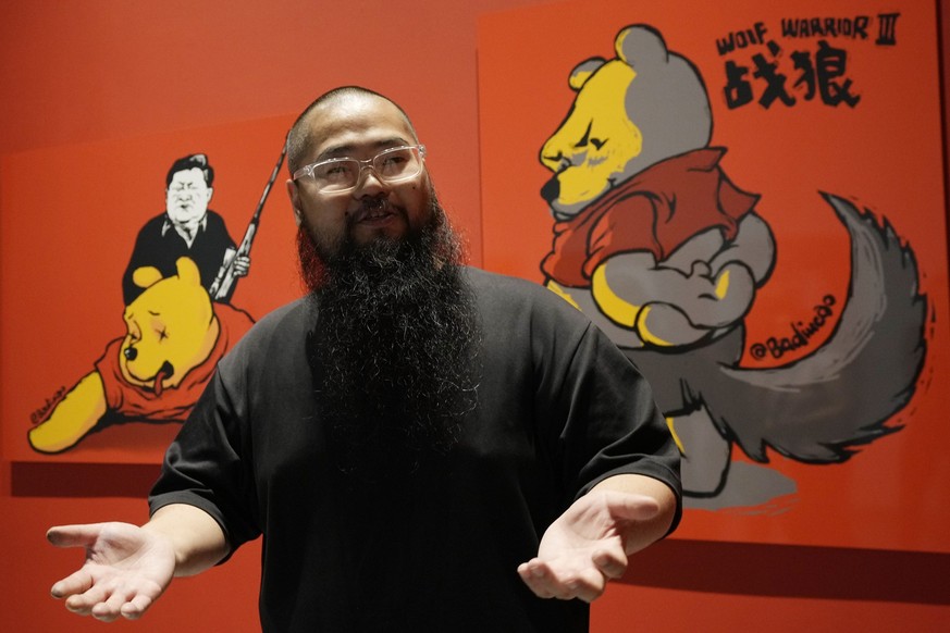 Chinese dissident artist Badiucao speaks as he stands in front of his works ahead of the opening of a new exhibition in Warsaw, Poland on Friday, June 16, 2023. The museum faced demands from the Chine ...