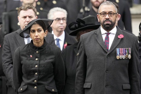 FILE - Britain&#039;s Home Secretary Suella Braverman stands with Foreign Secretary James Cleverly as they attend the Remembrance Sunday service at the Cenotaph on Whitehall in London, Sunday, Nov. 12 ...