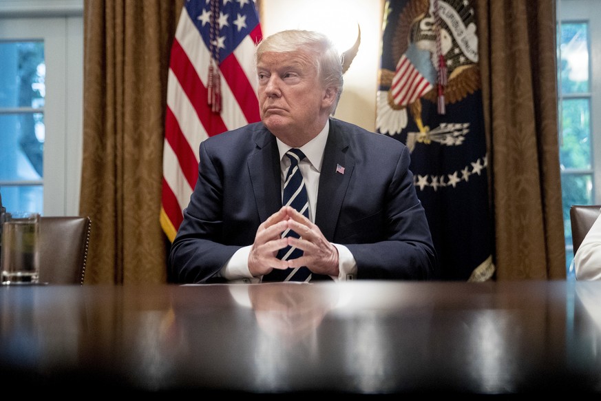 President Donald Trump waits for members of the media get set up before speaking in the Cabinet room of the White House, Tuesday, July 17, 2018, in Washington. Trump says he meant the opposite when he ...