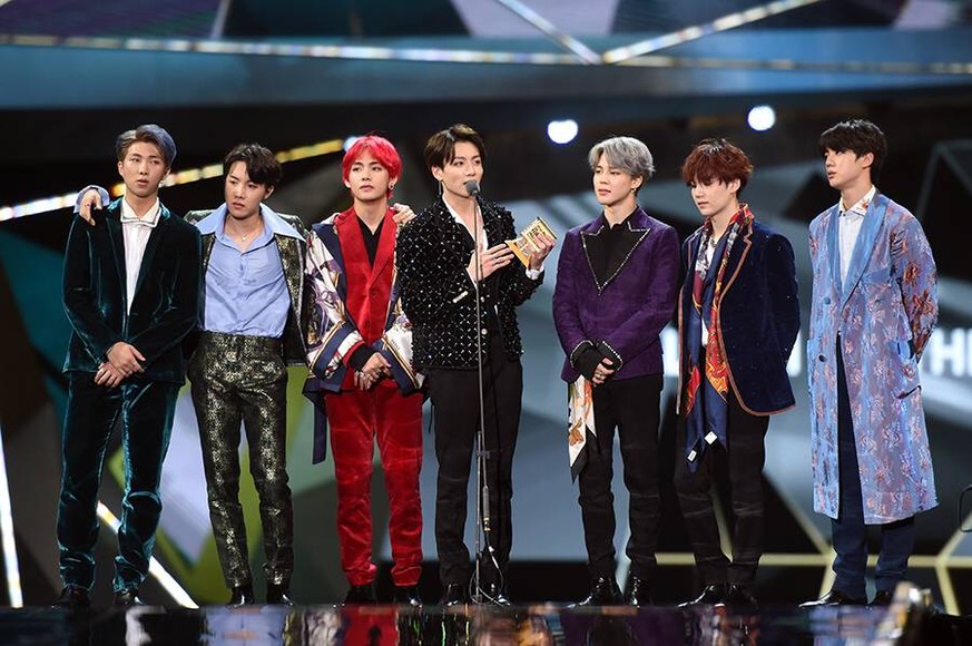 Members of South Korean boy band BTS, also known as the Bangtan Boys, pose with their trophy during the 2018 Mnet Asian Music Awards or MAMA in Hong Kong, China, 14 December 2018. BTS boys hot up 2018 ...