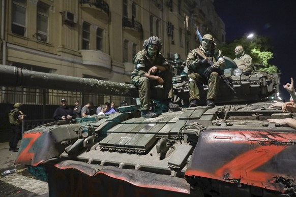 FILE - Members of the Wagner Group military company sit atop of a tank on a street in Rostov-on-Don, Russia, Saturday, June 24, 2023, prior to leaving an area at the headquarters of the Southern Milit ...