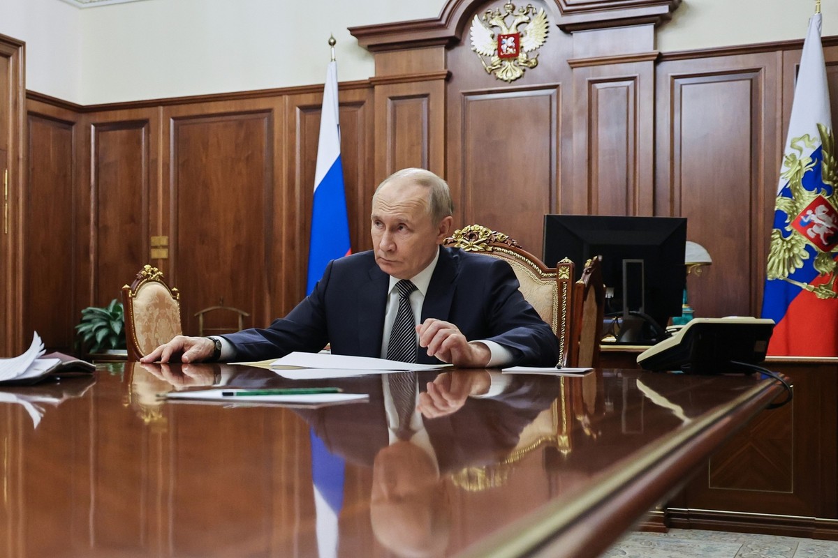 Russian President Vladimir Putin listens to Presidential Aide, Special Presidential Representative for Climate Issues Ruslan Edelgeriyev during their meeting at the Kremlin, in Moscow, Russia, Saturda ...