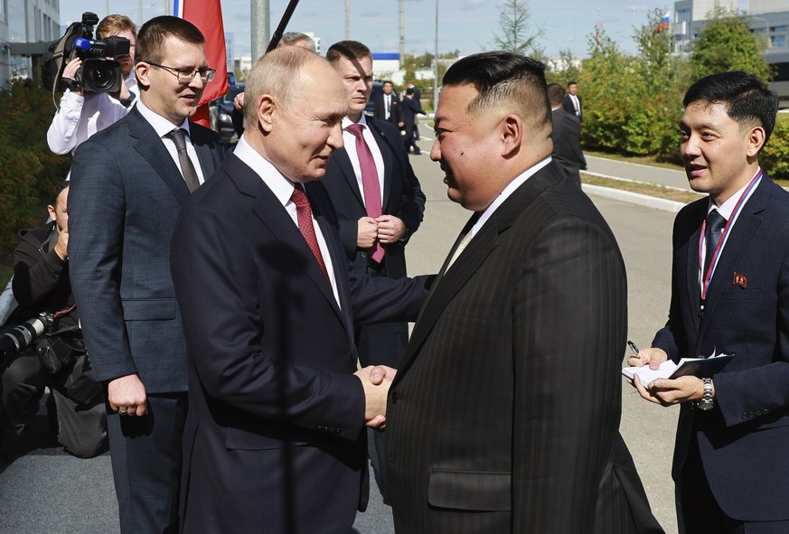 Russian President Vladimir Putin, left, and North Korea&#039;s leader Kim Jong Un shake hands during their meeting at the Vostochny cosmodrome outside the city of Tsiolkovsky, about 200 kilometers (12 ...