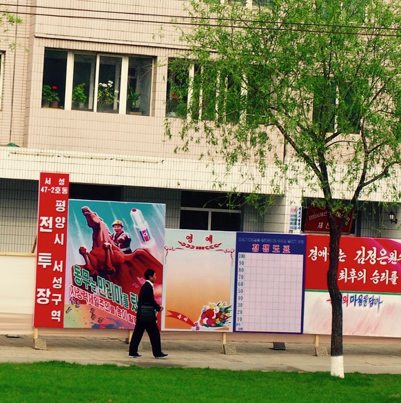 Pyongyang, DPRK (North Korea) - May 1st, 2016: North Korea may be barren of advertising but it is filled with portraits and propaganda posters depicting the leaders in various situations and spreading ...