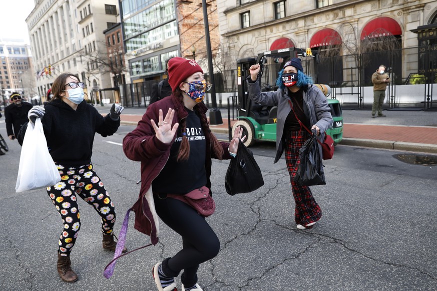 President Joe Biden supporters dance in the streets during 59th Presidential Inauguration, Wednesday, Jan. 20, 2021, in Washington. (AP Photo/Rebecca Blackwell)