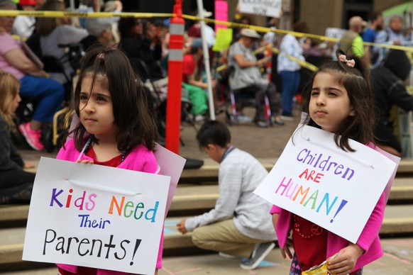 (180624) -- SAN DIEGO, June 24, 2018 -- Two girls take part in the Families Belong Together protest in San Diego, the United States, on June 23, 2018. Thousands of people marched in protest in the U.S ...