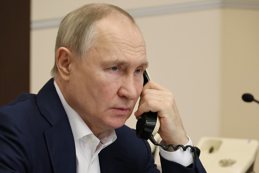 Russian President Vladimir Putin talks on the phone to eight-year-old Agatha Bylkova from the Kurgan region, a participant in the Fir Tree of Wishes charity campaign in Moscow, Russia, Tuesday, Jan. 3 ...