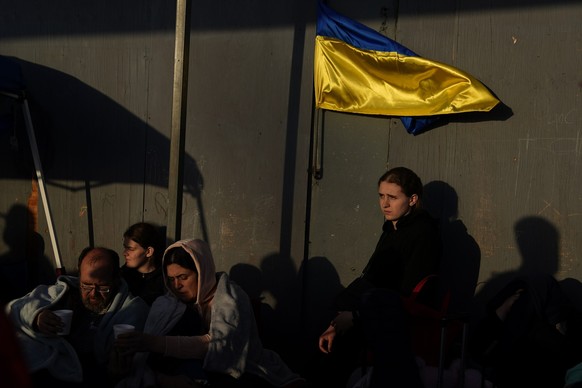 FILE - Ukrainian refugees wait near the U.S. border in Tijuana, Mexico, April 4, 2022. A month after Russia invaded Ukraine, refugees started showing up to the U.S.-Mexico border. Roughly 1,000 Ukrain ...