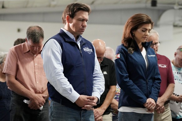 Republican presidential candidate Florida Gov. Ron DeSantis and his wife Casey bow their heads during a prayer at a campaign event, Wednesday, May 31, 2023, in Cedar Rapids, Iowa. (AP Photo/Charlie Ne ...