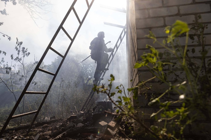 May 3, 2024, Kharkiv, Kharkiv, Ukraine: First responders work at the site after a Russian attack on Kharkiv. Preliminary data reveals the loss of an 82-year-old woman, bedridden due to illness, as a d ...