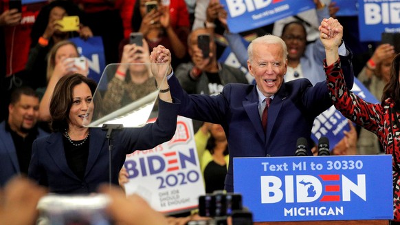 FILE PHOTO: Democratic U.S. presidential candidate and former Vice President Joe Biden and U.S. Senator Kamala Harris hold hands during a campaign stop in Detroit, Michigan, U.S., March 9, 2020. REUTE ...
