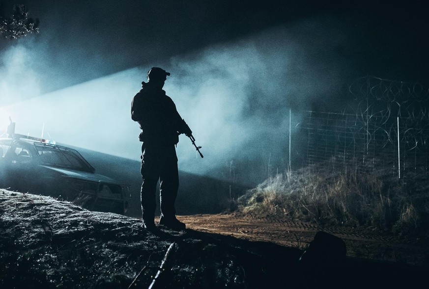 Kuznica, POLAND - NOVEMBER 09: In this handout image issued by the Polish Ministry of National Defence, soldiers from the Polish Armed Forces patrol the Belarus-Polish border on November 9, 2021 in Ku ...