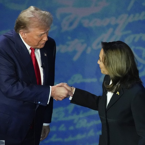 FILE - Republican presidential nominee former President Donald Trump and Democratic presidential nominee Vice President Kamala Harris shake hands before the start of an ABC News presidential debate at ...