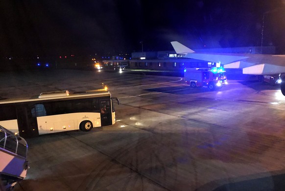 A fire engine is pictured through a window of the Airbus A340 government aircraft carrying Chancellor Angela Merkel and the German delegation to the G20 summit in Buenos Aires which was forced to land ...