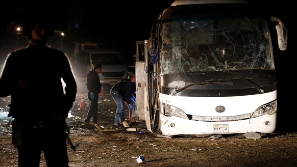 Police officers inspect a scene of a bus blast in Giza, Egypt, December 28, 2018. REUTERS/Amr Abdallah Dalsh