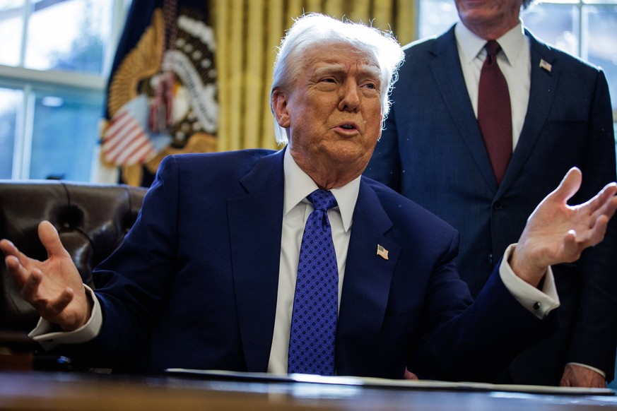 U.S. President Donald Trump signs two Executive Orders in the Oval Office at the White House in Washington, DC on Friday, February 14, 2025. The Executive Orders signed today were on federal funding g ...