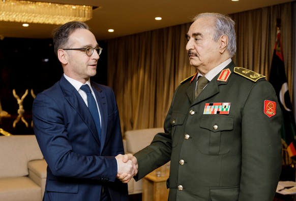 German Foreign Minister Heiko Maas shakes hands with Libya's commander Khalifa Haftar, in Benghazi, Libya, January 16, 2020, in this handout photo provided by the German Foreign Ministry. Auswaertiges ...
