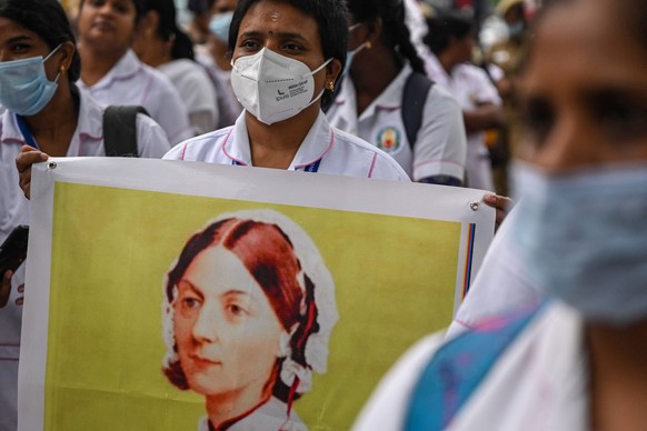 Nurses display a portrait of 19th-century nurse Florence Nightingale, one of the founders of modern nursing, during a procession marking International Nurses Day, celebrated on her birthday in Chennai ...