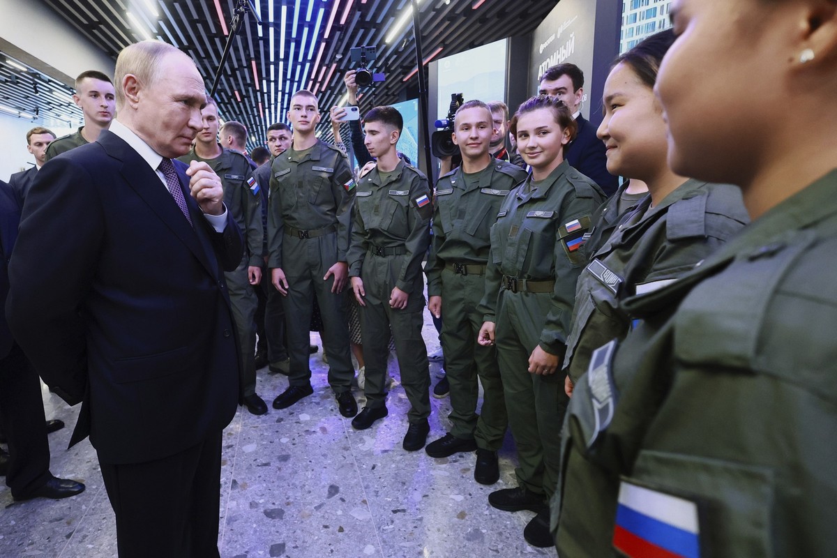 Russian President Vladimir Putin, left, speaks with cadets of the Military-Sports Training and Patriotic Education Center after visiting the interactive exhibition dedicated to the 155th Separate Guar ...