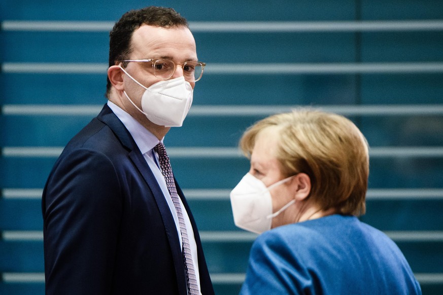 BERLIN, GERMANY - JANUARY 06: German Chancellor Angela Merkel (R) and German Health Minister Jens Spahn wear face masks as they stand next to each other during the beginning of the weekly meeting of t ...
