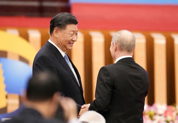 China holds Belt and Road int l forum Chinese President Xi Jinping L and Russian President Vladimir Putin shake hands at an international forum on the Belt and Road infrastructure initiative at the Gr ...