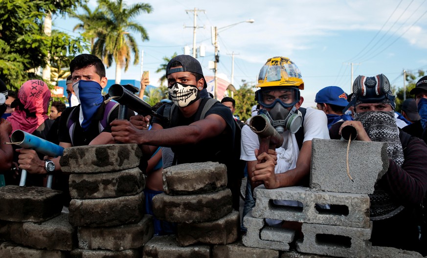 Demonstrators stand behind a barricade during clashes with riot police during a protest against Nicaragua's President Daniel Ortega's government in Managua, Nicaragua May 30, 2018. REUTERS/Oswaldo Riv ...
