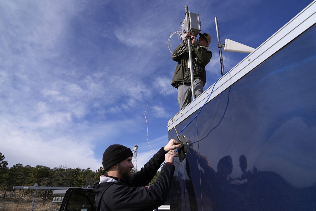Brothers Parker, left, and Carver Cammans install cloud seeding equipment Saturday, Dec. 3, 2022, in Lyons, Colo. The technique to get clouds to produce more snow is being used more as the Rocky Mount ...