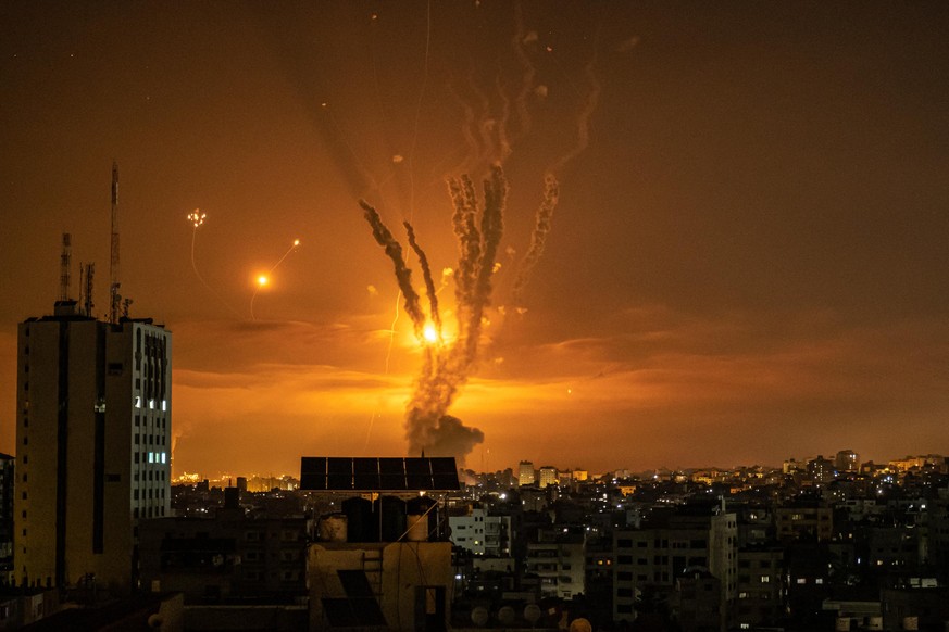 GAZA CITY, GAZA - MAY 14: Rockets launched towards Israel from the northern Gaza Strip and response from the Israeli missile defense system known as the Iron Dome leave streaks through the sky on May  ...