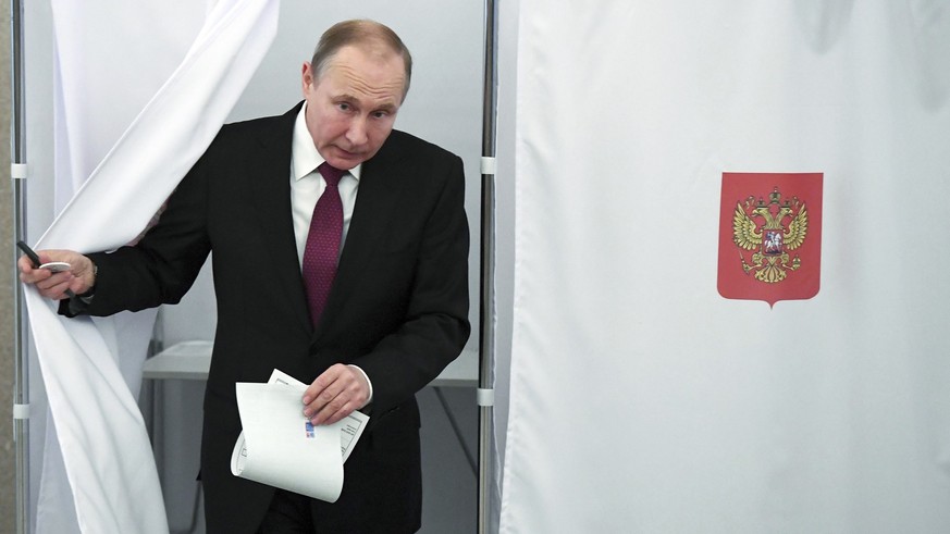 FILE - Russian President and Presidential candidate Vladimir Putin exits a polling booth as he prepares to cast his ballot during Russia&#039;s presidential election in Moscow, Russia, Sunday, March 1 ...