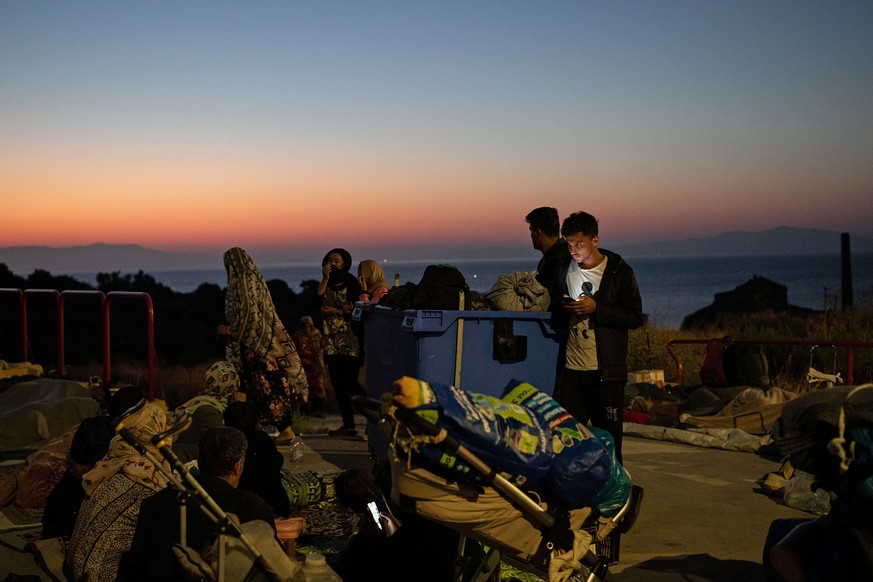 Refugees and migrants find shelter at the premises of a gas station, following a fire at the Moria camp on the island of Lesbos, Greece, September 11, 2020. REUTERS/Alkis Konstantinidis