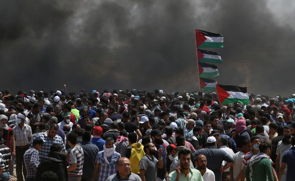 Palestinian demonstrators gather during a protest against U.S. embassy move to Jerusalem and ahead of the 70th anniversary of Nakba, at the Israel-Gaza border in the southern Gaza Strip May 14, 2018.  ...