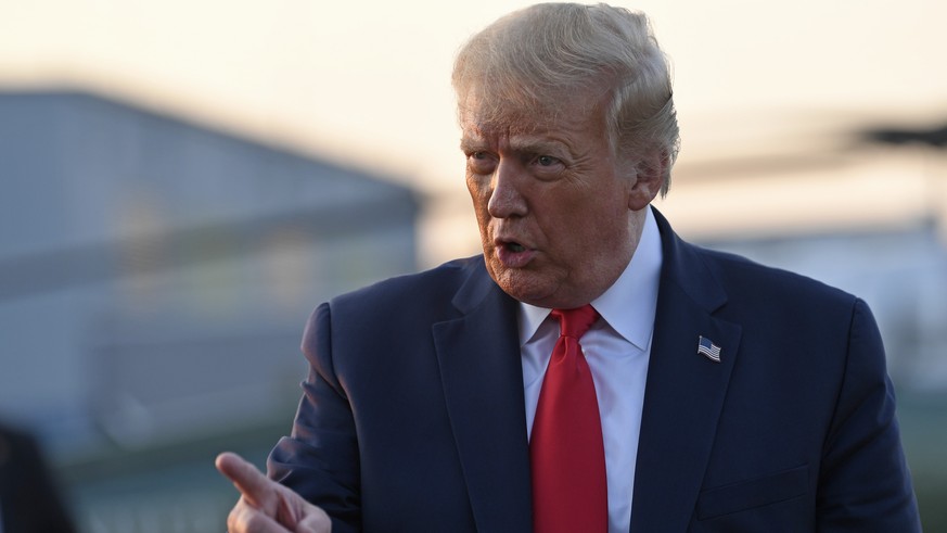 President Donald Trump talks with reporters before departing from Morristown Municipal Airport in Morristown, N.J., Sunday, Aug. 9, 2020. Trump was returning to Washington after spending the weekend a ...