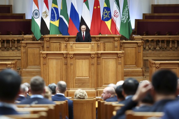 Russian President Vladimir Putin addresses the BRICS Parliamentary Forum in St. Petersburg, Russia, Thursday, July 11, 2024. (Valery Sharifulin, Sputnik, Kremlin Pool Photo via AP)