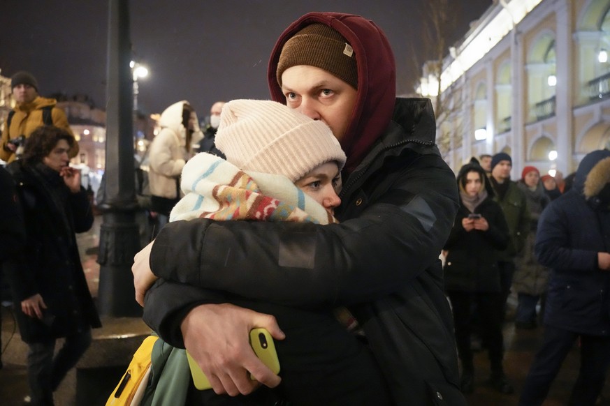 A couple stand and embrace during a gathering in St. Petersburg, Russia, Friday, Feb. 25, 2022. Shocked Russians turned out by the thousands Thursday to decry their country's invasion of Ukraine as em ...