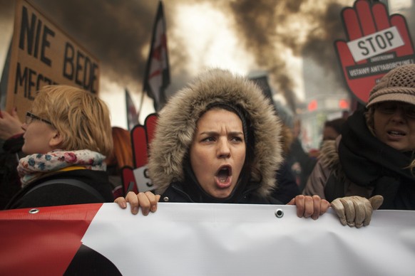 Feminists after light up a flares during strike against restrictions in Abortion Law in Warsaw on March 23, 2018. (Photo by Maciej Luczniewski/NurPhoto)