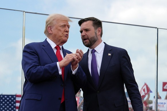 Republican presidential nominee former President Donald Trump and Republican vice presidential nominee Sen. JD Vance, R-Ohio, stand on stage at a campaign rally at North Carolina Aviation Museum, Wedn ...