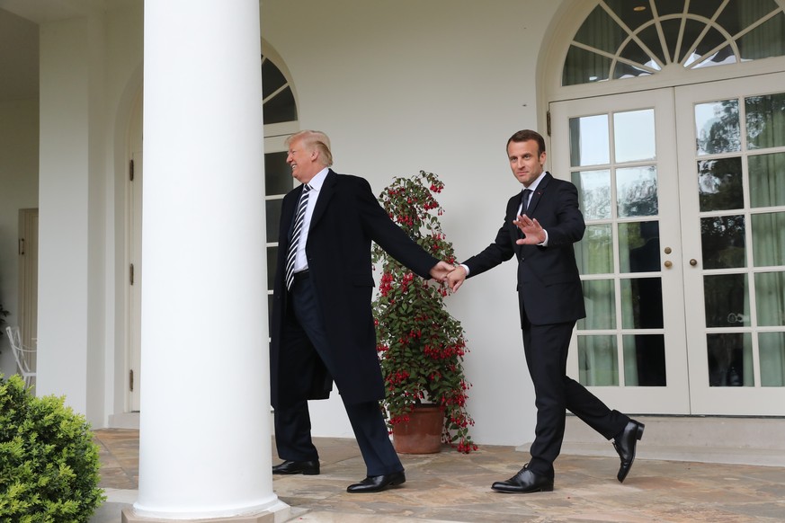 President Donald Trump and French President Emmanuel Macron walk to the Oval Office of the White House in Washington, Tuesday, April 24, 2018. Trump said the partnership he forged with Macron at the s ...
