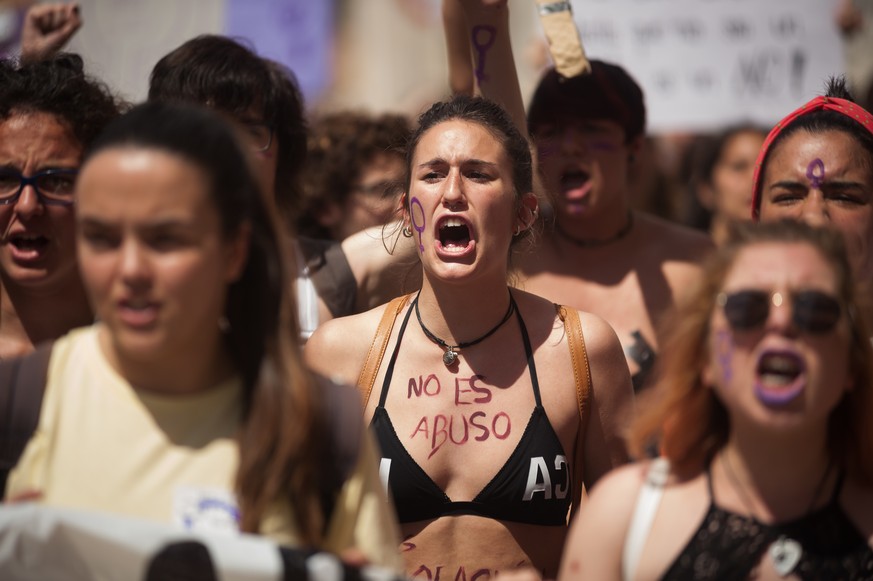 May 10, 2018 - Malaga, Spain - A protester with her body painted with the words: ''It is not abuse, it is rape'' takes part in a demonstration during a feminist student strike against the sentence of  ...