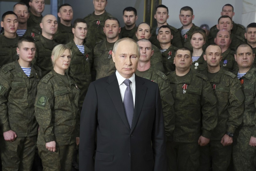 FILE – Russian President Vladimir Putin speaks in his annual televised New Year&#039;s message after an awards ceremony during a visit to the headquarters of the Southern Military District, at an unkn ...