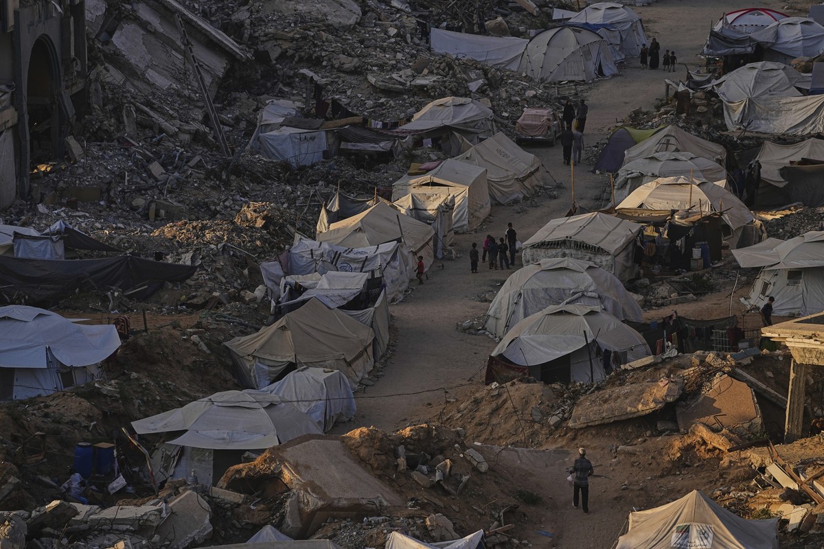 A tent camp for displaced Palestinians stretches among the ruins of buildings destroyed by Israeli bombardments in west of Gaza City, Saturday, June 21, 2025. (AP Photo/Jehad Alshrafi)