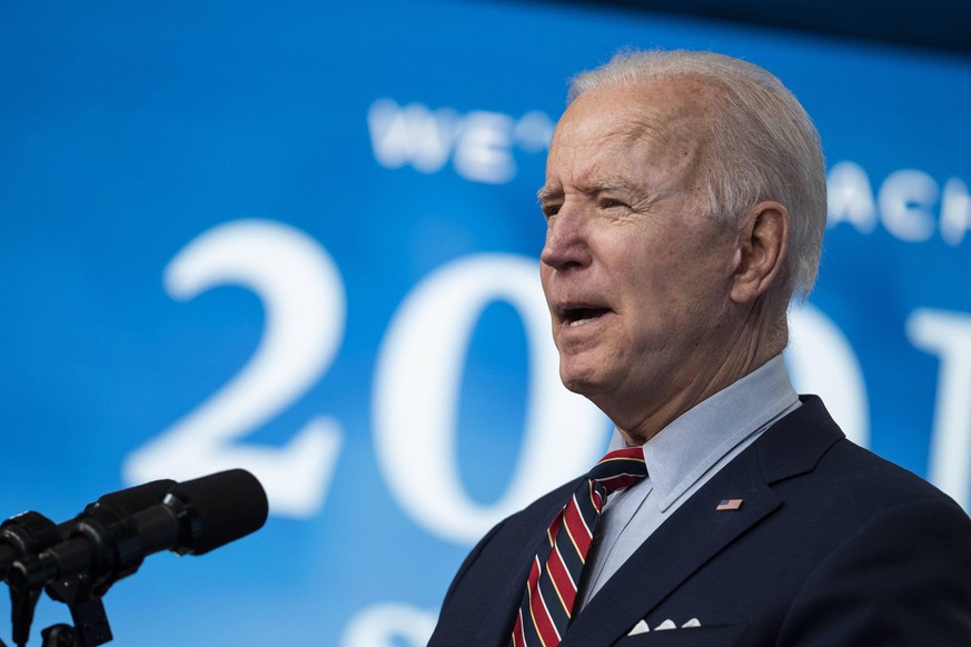 U.S. President Joe Biden speaks in the Eisenhower Executive Office Building in Washington, D.C., U.S., on Wednesday, April 21, 2021. Biden announced that the U.S. will achieve its goal on Thursday of  ...