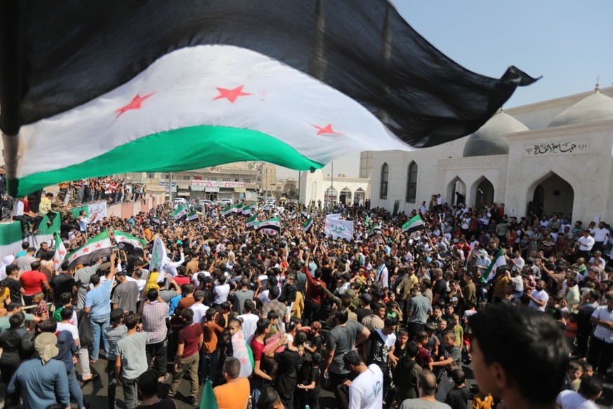 ALEPPO, SYRIA - AUGUST 25: People gather to protest against Bashar al-Assad regime in al-Bab district of Aleppo, Syria on August 25, 2023. Thousands of people gathered in Syria&#039;s Idlib, Aleppo, D ...