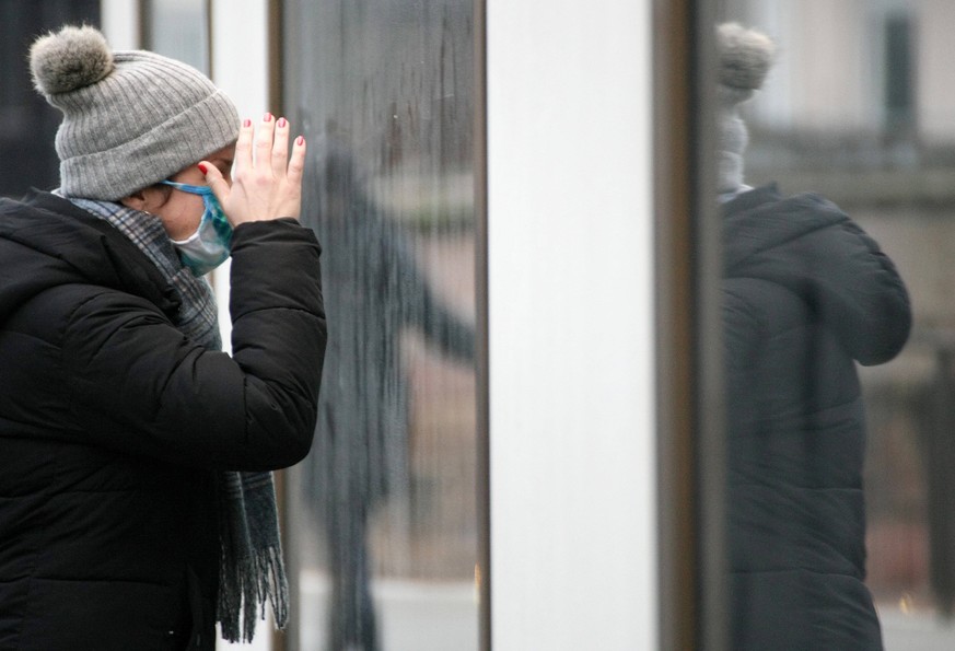 a women with Safety Mask looks at the future during in the Hard Lockdown of the Covid 19 Coronavirus Pandemie in Nuremberg Nurnberg , Bayern , Deutschland . January 01 , 2021.