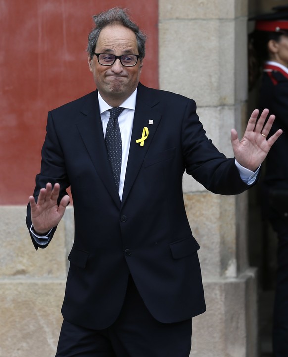 Newly appointed Catalan president Quim Torra, leaves the parliament after a parliamentary vote session in Barcelona, Spain, Monday, May 14, 2018. Catalan lawmakers have ended a half-year power vacuum  ...