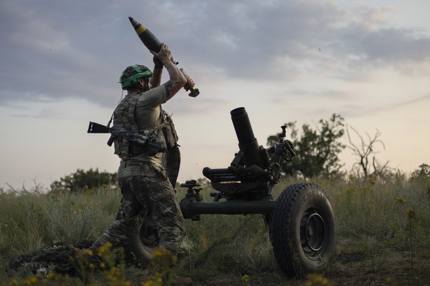 FILE - A Ukrainian serviceman of the 3rd Assault Brigade fires a 122mm mortar towards Russian positions at the front line, near Bakhmut, Donetsk region, Ukraine, Sunday, July 2, 2023. Employees from a ...